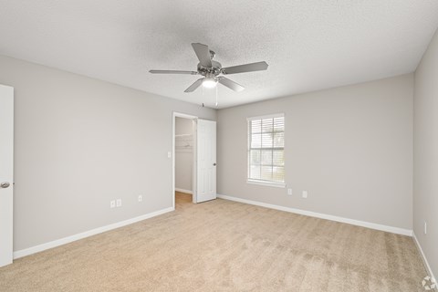 A room with a ceiling fan and carpeted floor. at Reserve at Park Place Apartment Homes, Hattiesburg, 39402