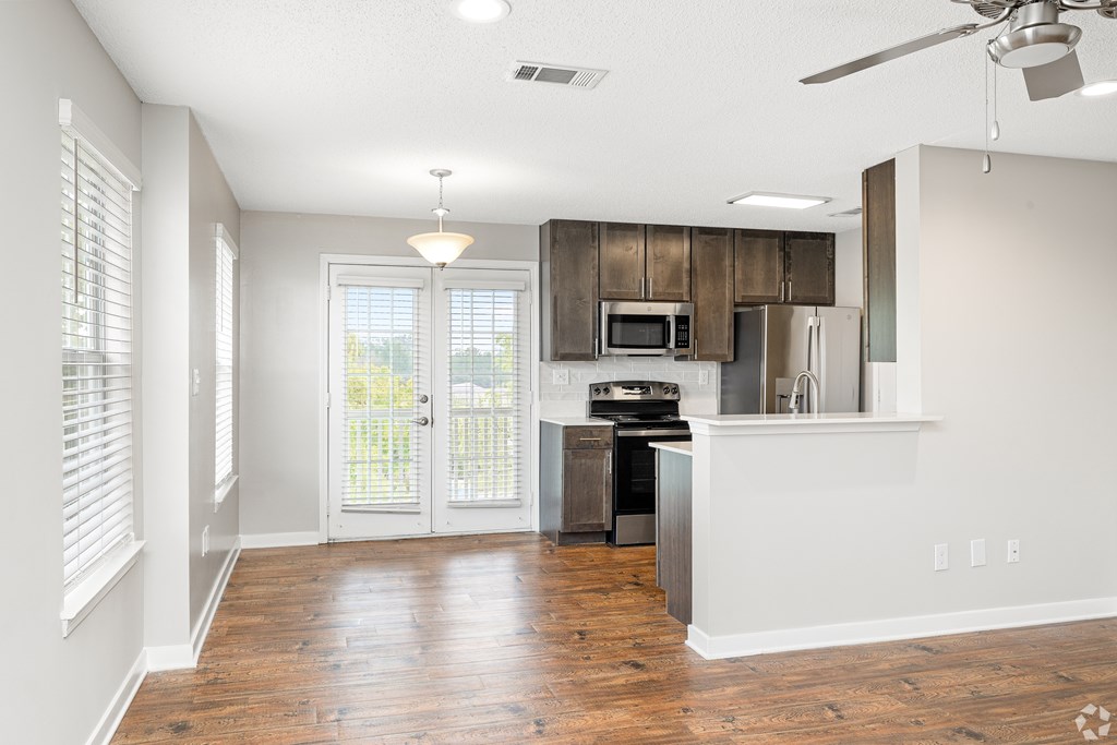 A kitchen with a refrigerator, microwave, and stove top oven. at Reserve at Park Place Apartment Homes, Hattiesburg, MS, 39402