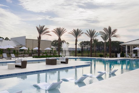Resort style pool and chairs at Saltaire Apartment Homes in Santa Rosa Beach, FL