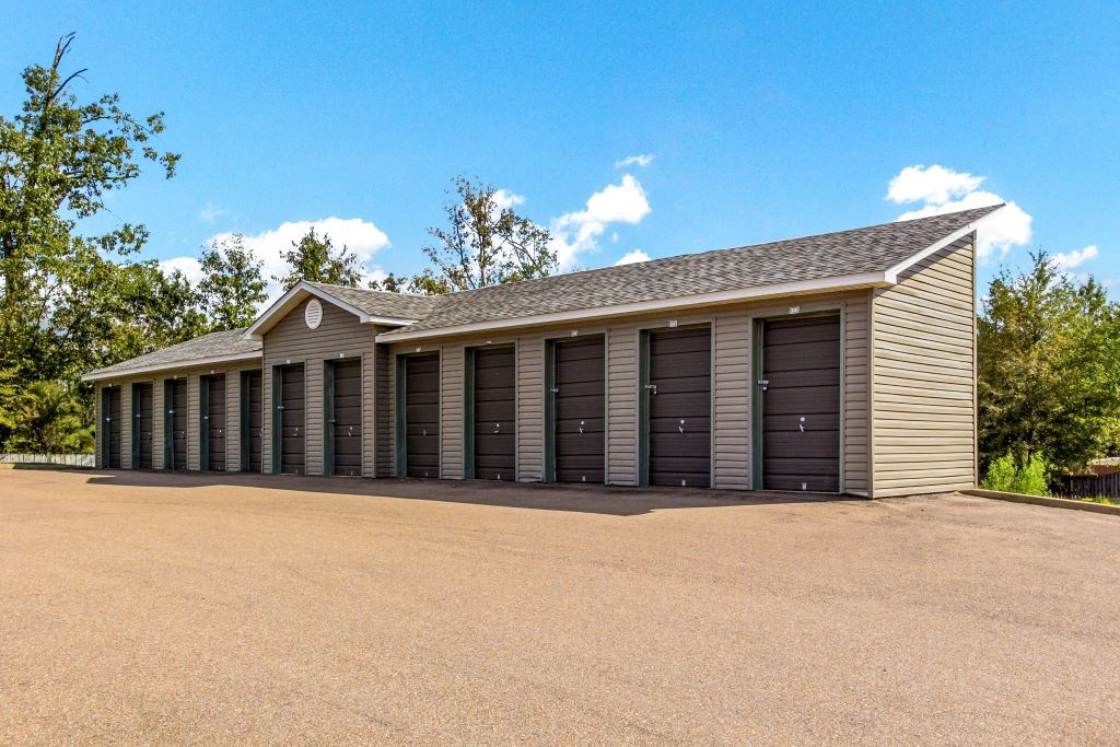 a row of garage doors in a row with a blue sky in the background at Ashford Place Apartment Homes, Mississippi