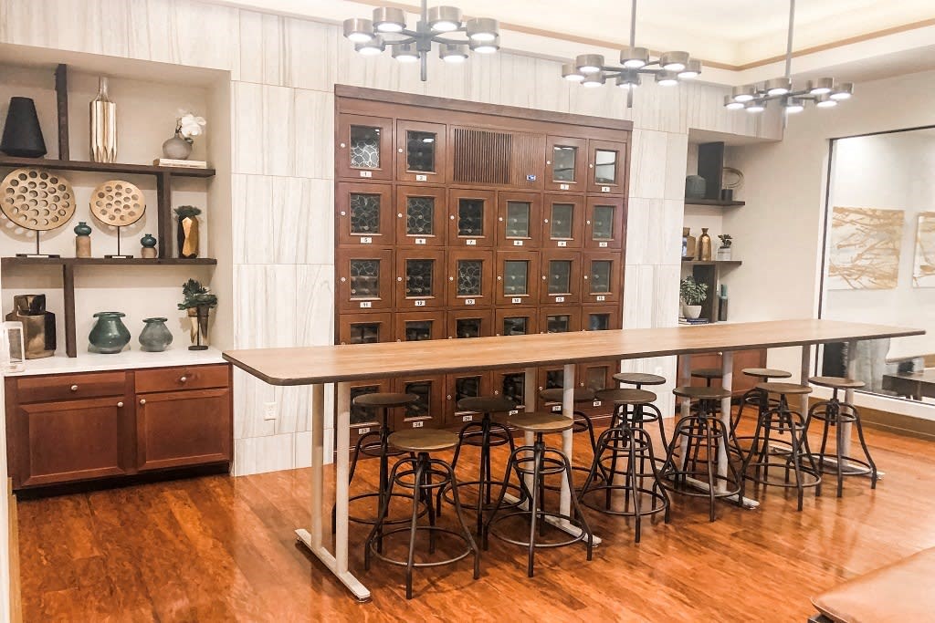 a kitchen with a table and chairs in front of a cabinet at The Retreat Apartment Homes in ND 58801
