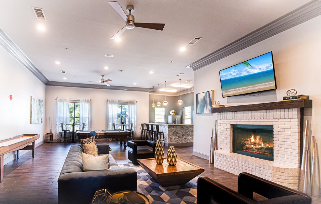 the living room has a fireplace and a seating area  at The Madison Apartment Homes in Tyler, 75703
