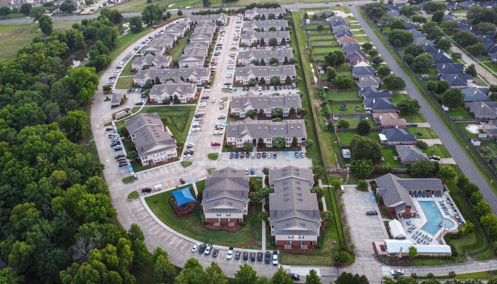 an aerial view of a neighborhood with several houses and a swimming pool  at Landing at Willow Bayou Apartment Homes, Bossier City, Louisiana