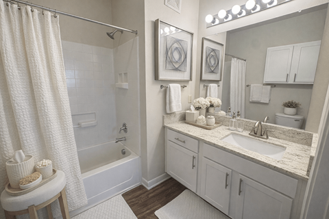 A white bathroom with a shower, sink, and toiletries.