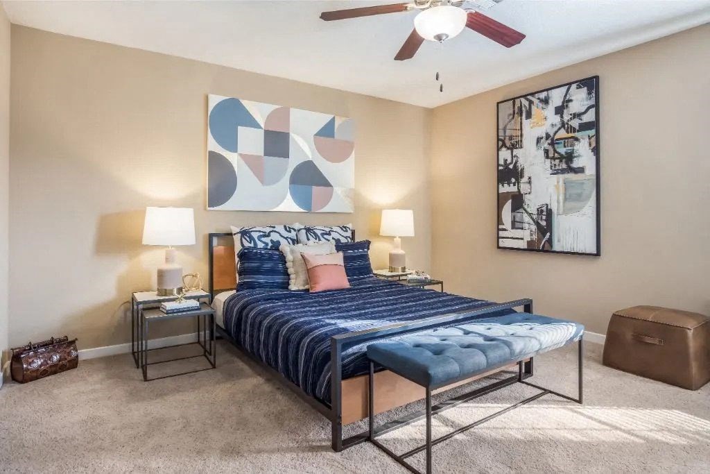 a bedroom with a bed and a ceiling fan at Reserve at Gulf Hills Apartment Homes in Ocean Springs, 39564
