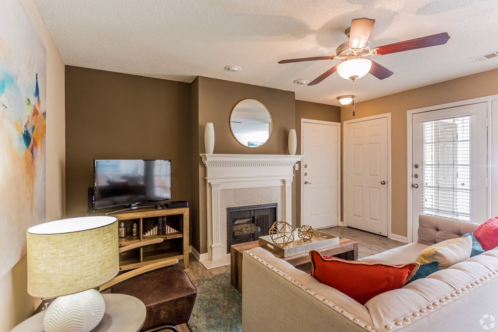A living room with a fireplace and a television. at Quail Ridge Apartment Homes, Tennessee