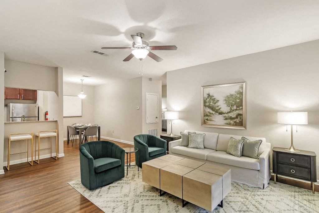 a living room with a couch and two chairs  at Highpointe Apartment Homes, Brandon, MS, 39042