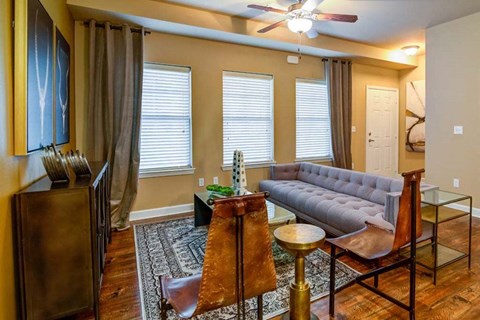 a living room with a couch and a table at The Retreat Apartment Homes in ND 58801