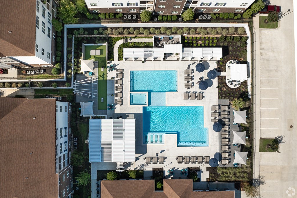 arial view of a swimming pool on the roof of a building at The Met Apartment Homes, Hattiesburg, Mississippi