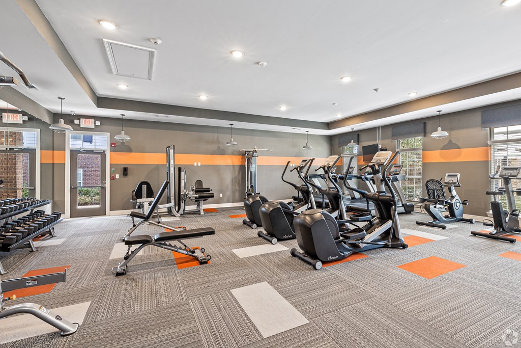 a gym with cardio equipment and weights at the apartments at The Met Apartment Homes, Mississippi