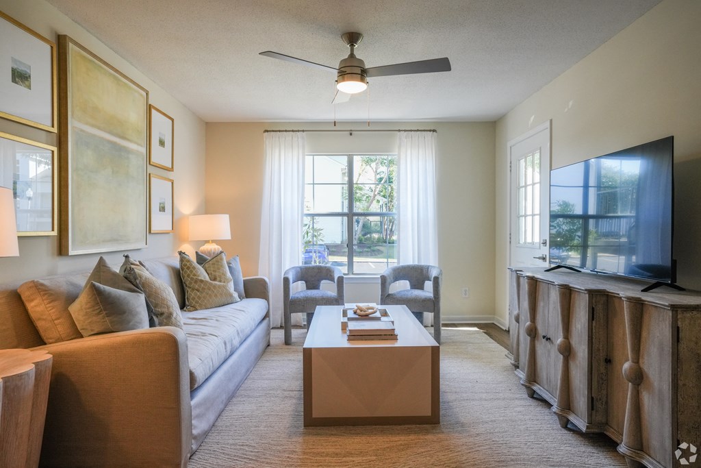 a living room with a couch and a coffee table at The Vineyard at Castlewoods Apartment Homes in Brandon, Mississippi 39047