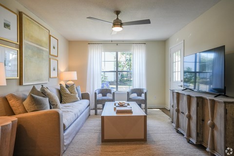 a living room with a couch and a coffee table at The Vineyard at Castlewoods Apartment Homes in Brandon, Mississippi 39047