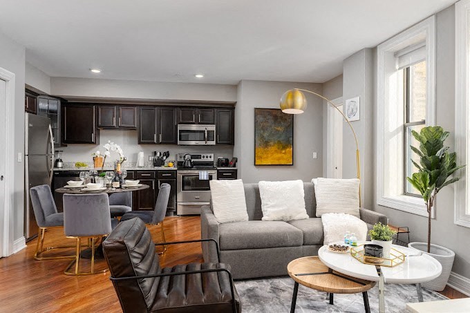 a living room and kitchen with a couch and a table