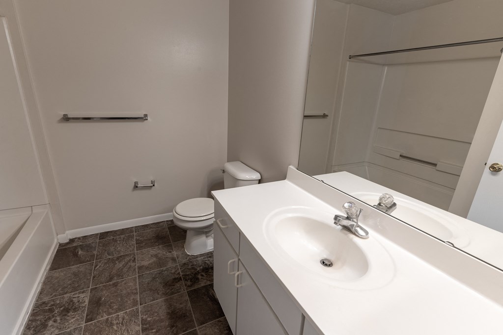 an empty bathroom with a sink and a toilet