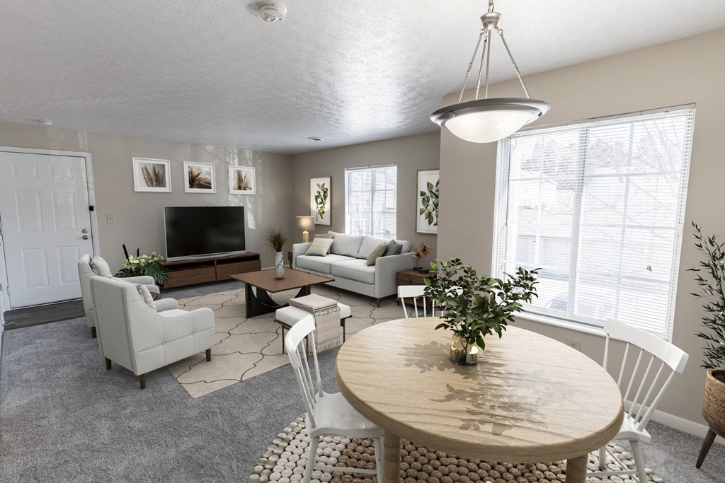 a living room and dining room with couches and a table
