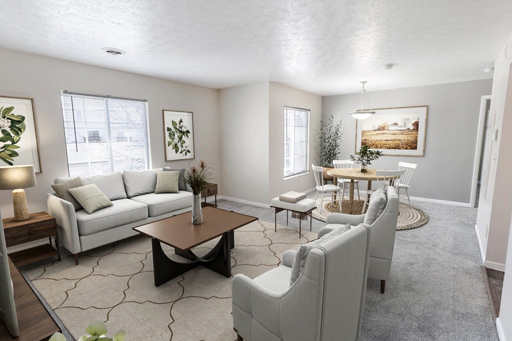 a living room with couches and chairs and a dining table
