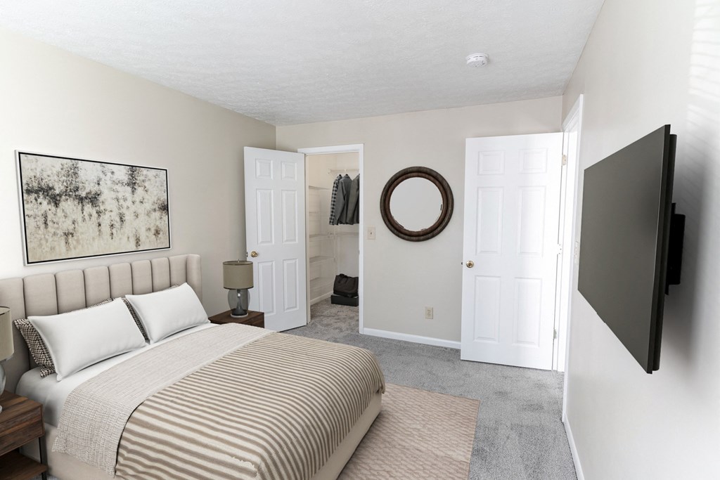 a bedroom with a bed and a door to a bathroom