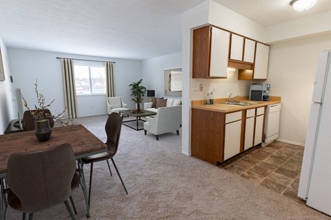 an open living room and kitchen with a dining room table and chairs