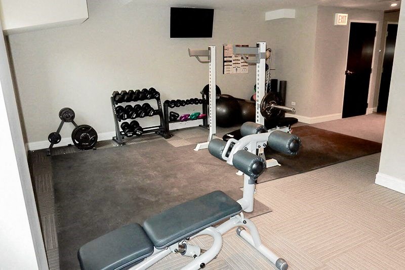 a gym with weights and other equipment in a room