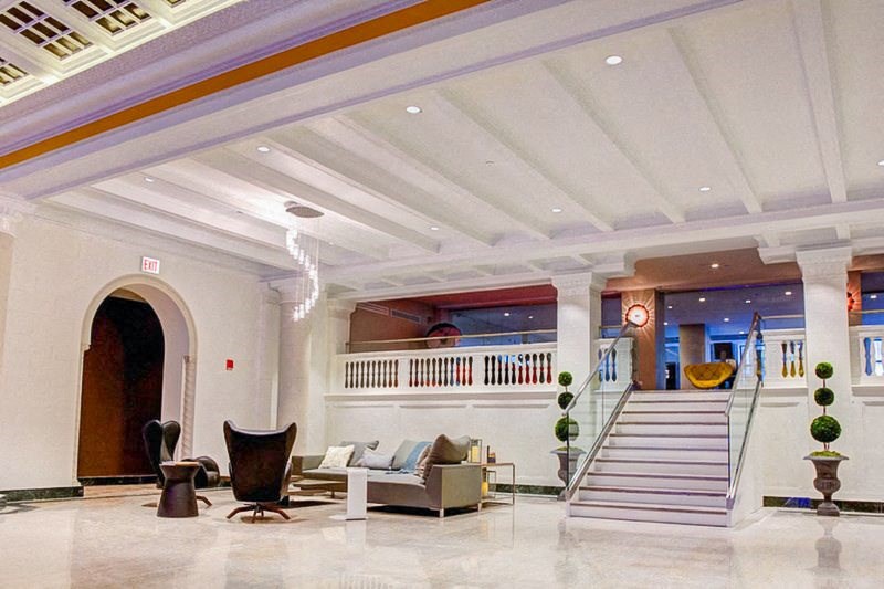 a lobby with couches and chairs and a staircase