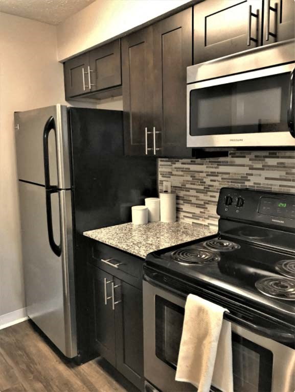 Modern kitchen with stainless steel appliances and modern backsplash at Camelot East Apartments, Fairfield, OH, 45014