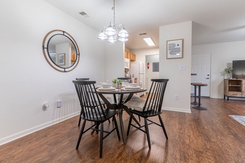 a dining room with a table and chairs and a kitchen