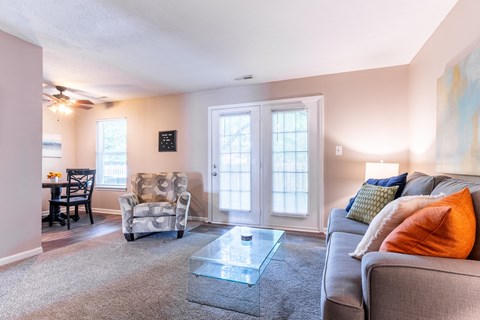 a living room with a couch and a glass coffee table