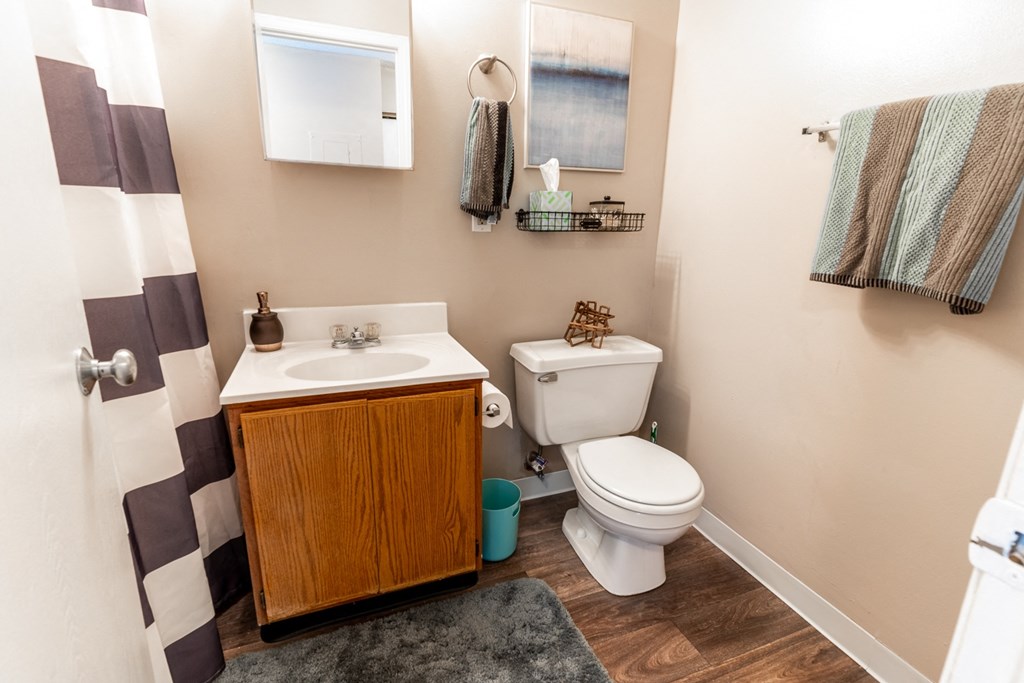an updated bathroom with a toilet sink and shower at HUB of New Albany Apartments, New Albany, 47150