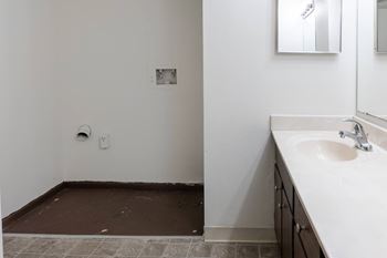 an empty bathroom with a sink and a mirror