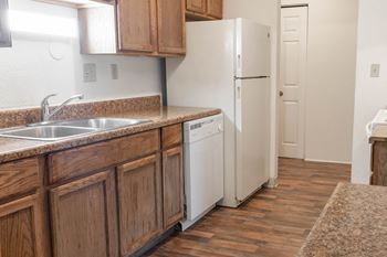 a kitchen with wooden cabinets and a white refrigerator