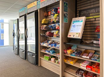Whit Market convenience store with a large display of snacks and refreshing drinks at The Whit Apartments in Indianapolis, IN 46204 - Photo Gallery 57