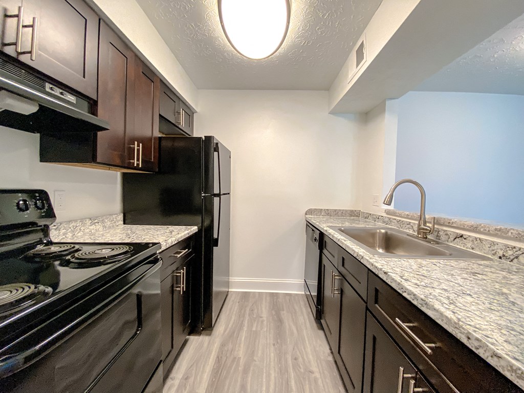 Modern kitchen with faux wood flooring at Camelot East Apartments, Fairfield, OH