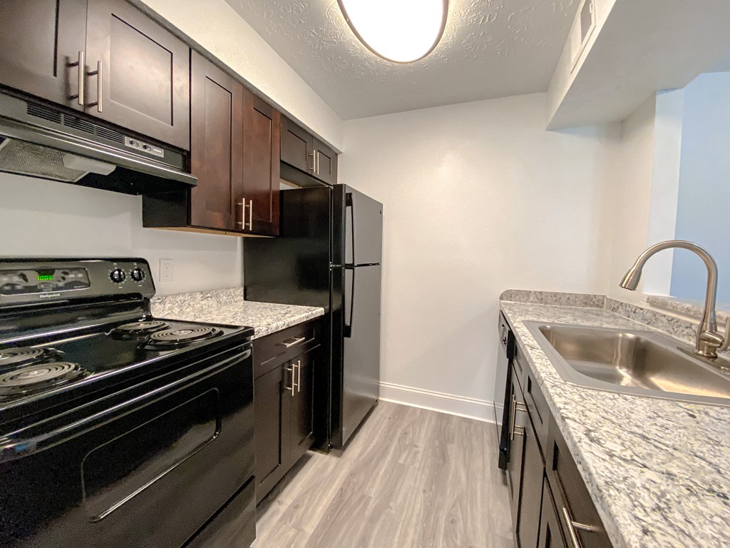 Spacious kitchen with wood style plank flooring at Camelot East Apartments, Fairfield, Ohio