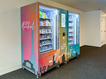 Whit Market vending machine with snacks, drinks, and convenience items at The Whit Apartments in Indianapolis, IN 46204