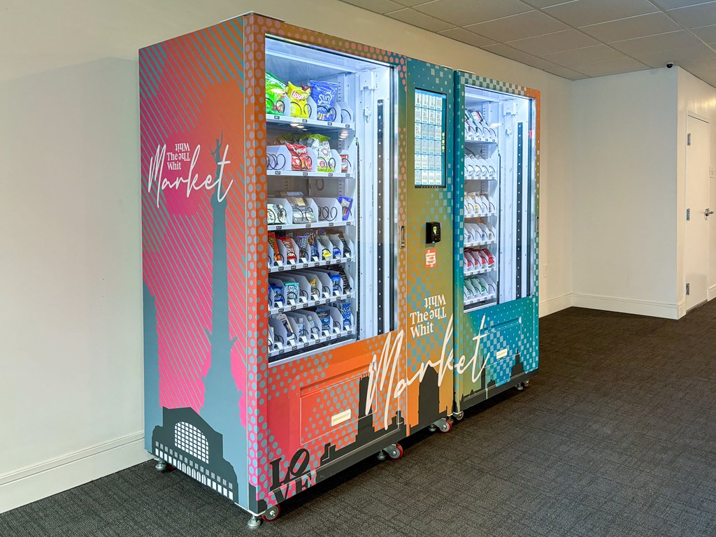 Whit Market vending machine with snacks, drinks, and convenience items at The Whit Apartments in Indianapolis, IN 46204