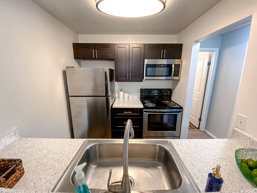 Modern kitchen with stainless steel appliances at Camelot East Apartments, Ohio