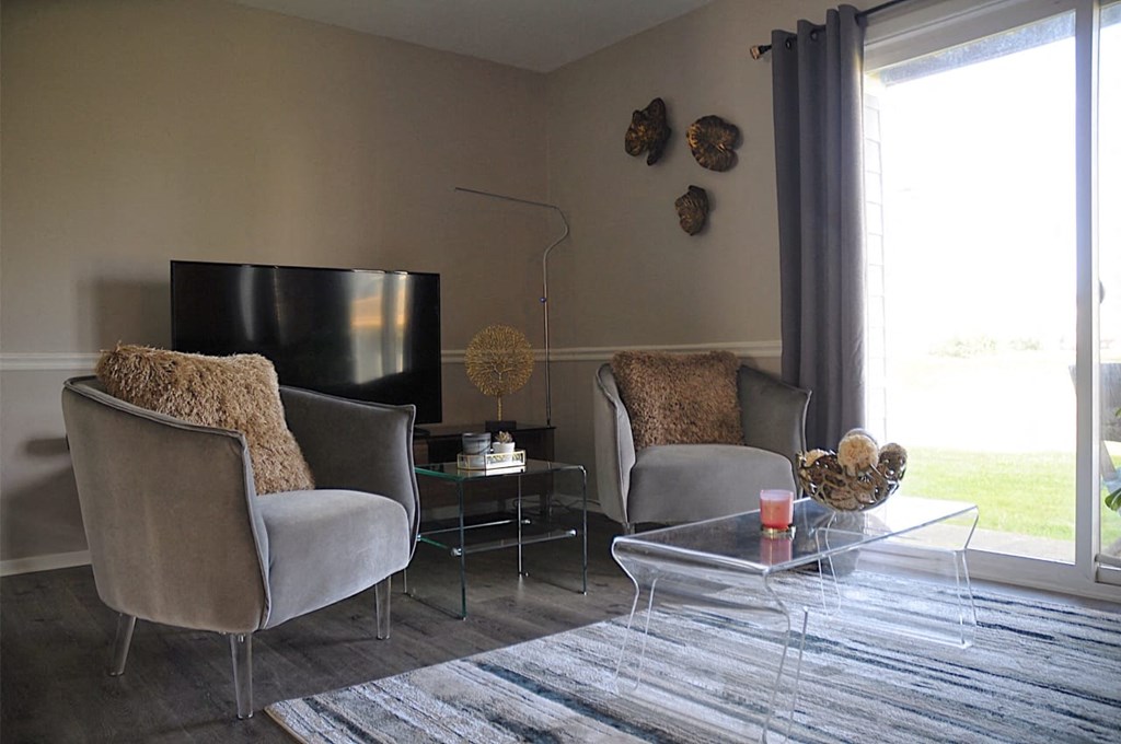 Spacious living room with modern faux wood flooring at Pickwick Farms Apartments in Indianapolis, IN