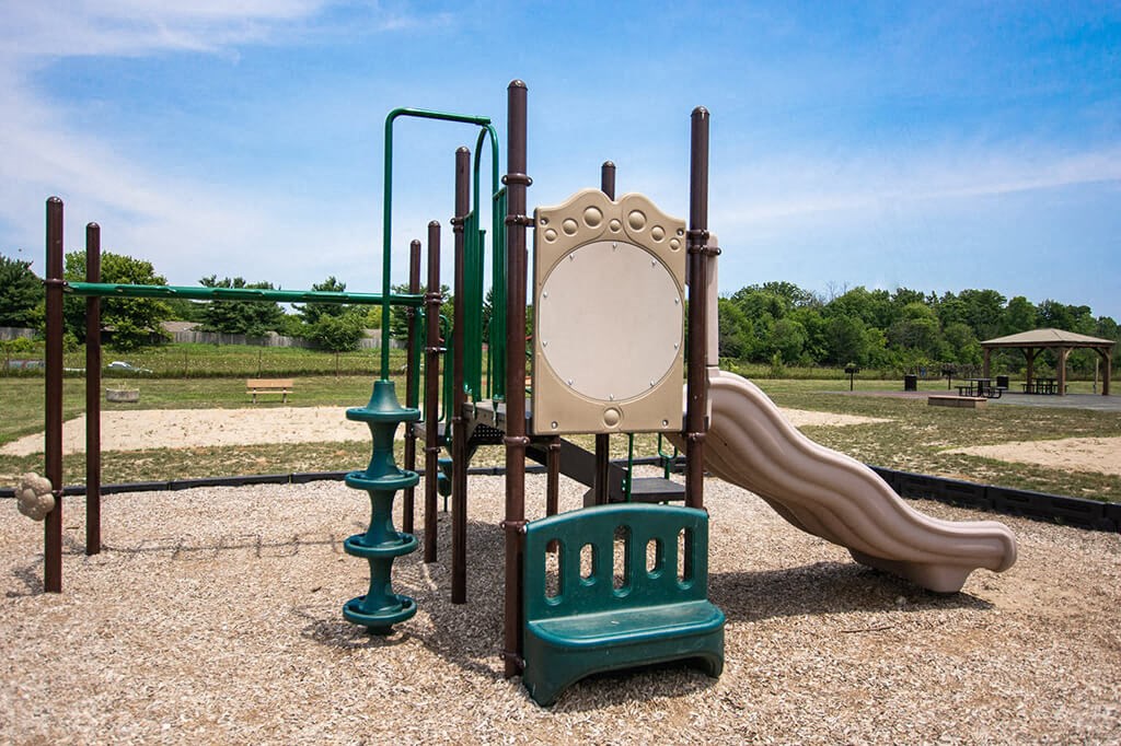 Community Playground with Swing Set at Pickwick Farms Apartments in Indiana 46260