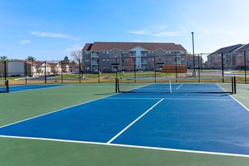 A tennis court at The Village at Sandstone Apartments, Greenwood, IN 46142