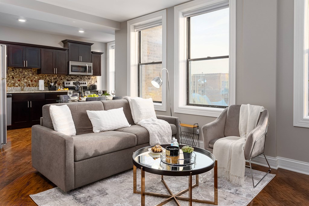 a living room with a couch and a chair and a table