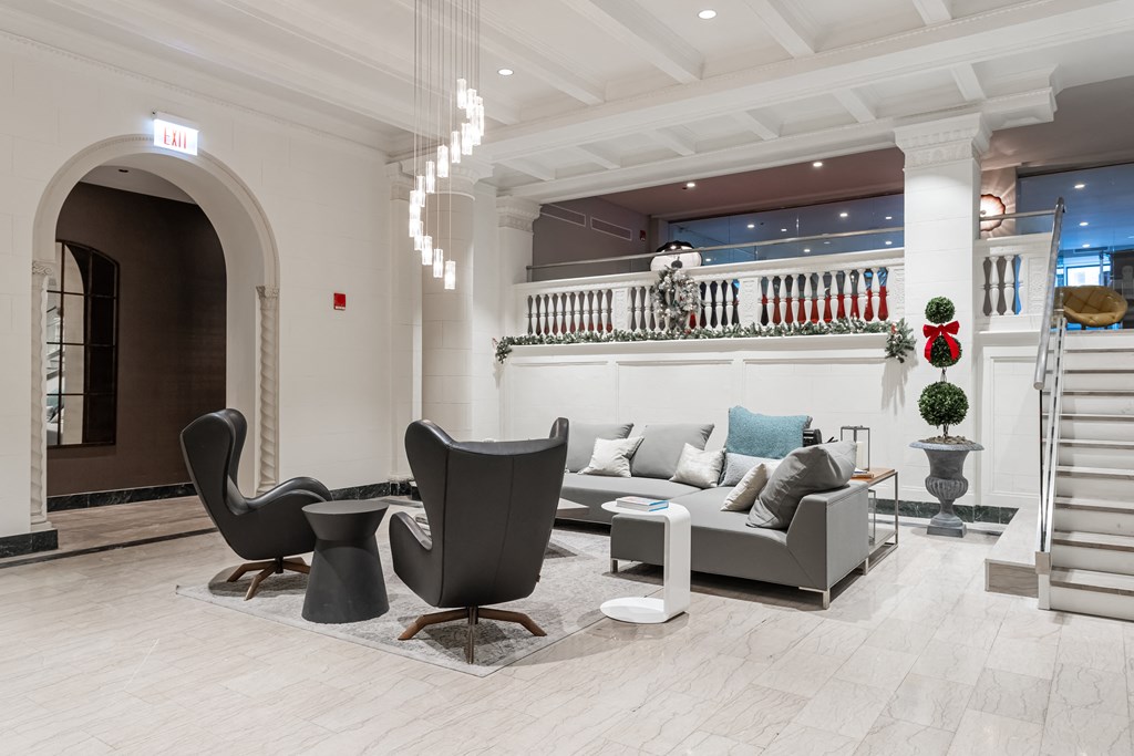 a lobby with couches and chairs and a staircase