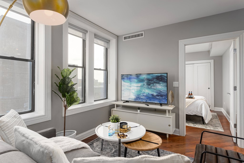 a living room with a couch and a table and a tv