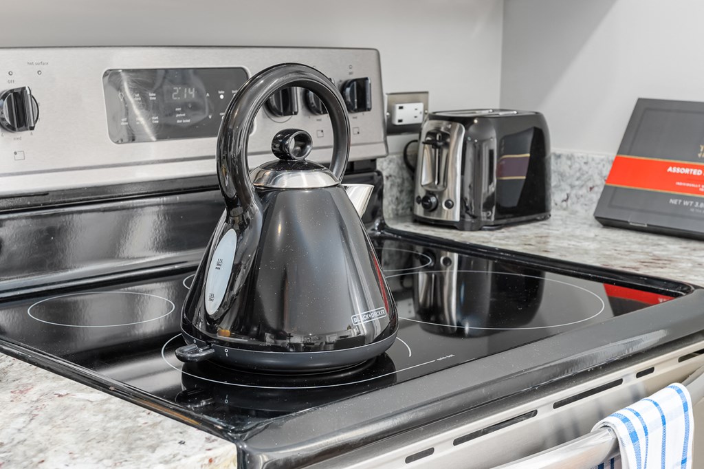 a kitchen with a kettle on top of a stove