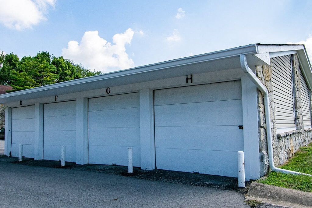 a white garage with a blue roof