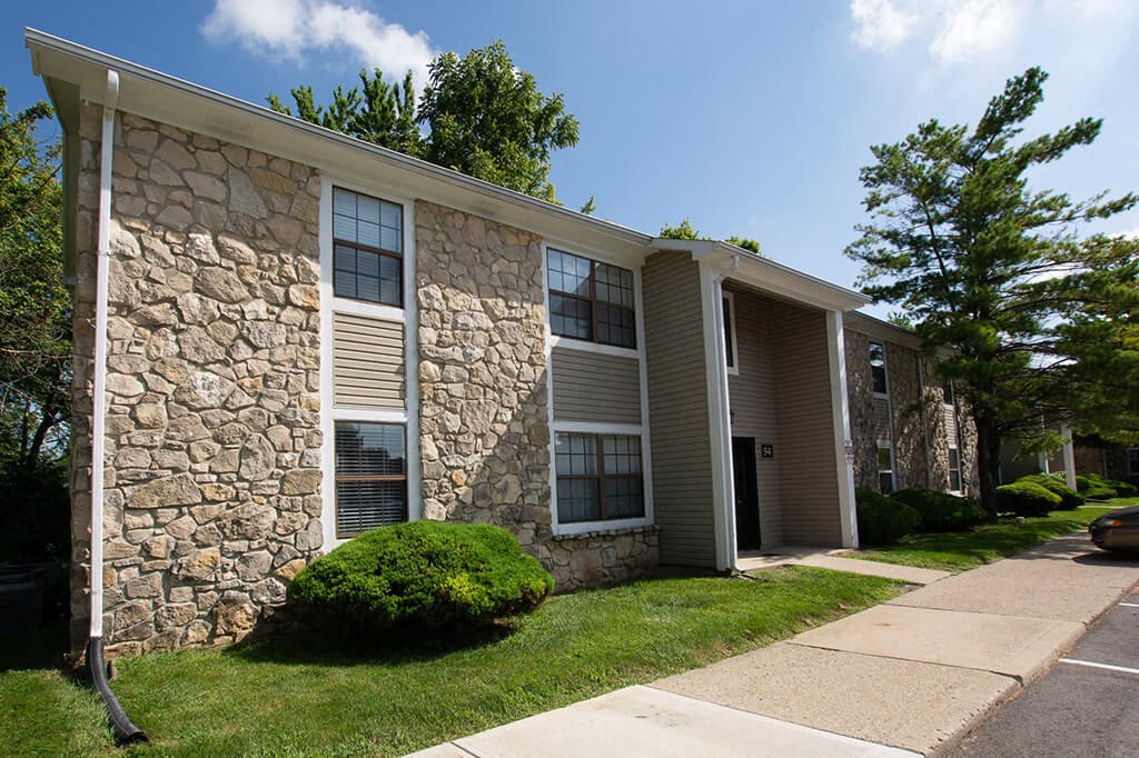 a stone building with a sidewalk in front of it