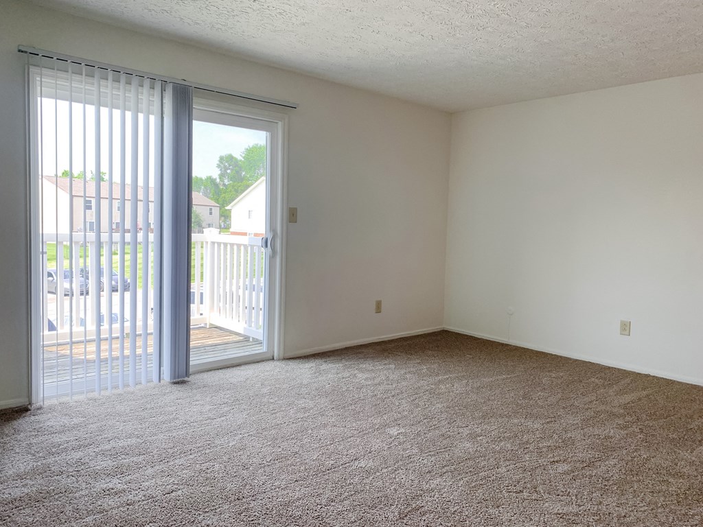 Spacious living room with balcony at Waterstone Place Apartments, Indianapolis 