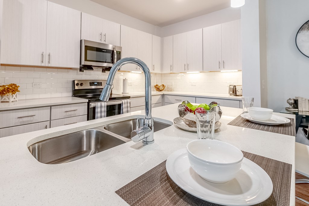 a kitchen with a sink and a counter with a bowl on it at The Whit Apartments, Indianapolis, Indiana