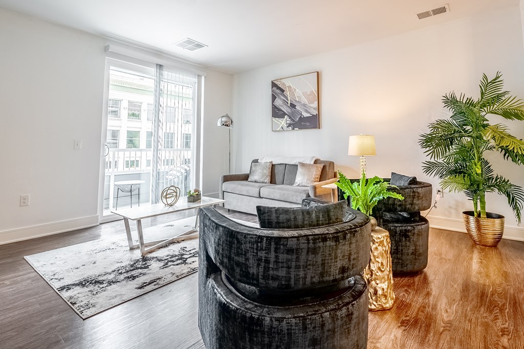 a living room with a couch and a round table at The Whit Apartments, Indiana, 46204
