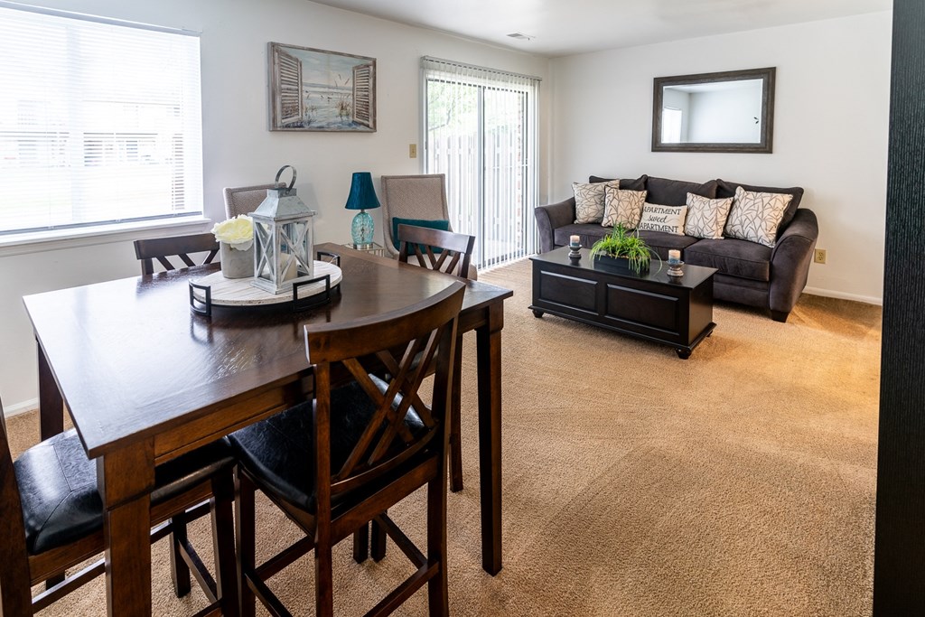 an open living room and dining room with a couch and a table