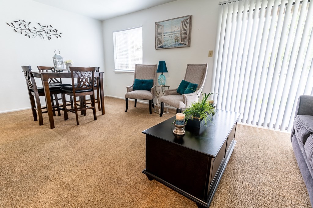 an open living room and dining room with a table and chairs at Lake Camelot Apartments, Indianapolis, Indiana